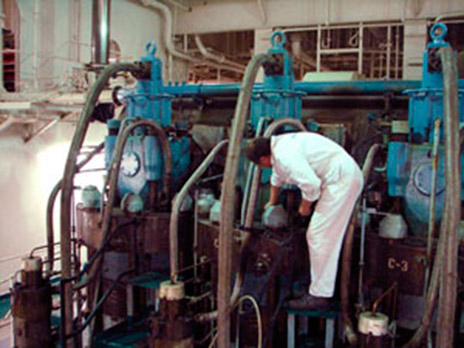 Technician performing maintenance on industrial equipment